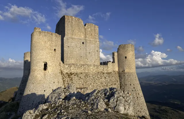 Ruined stone towers of Rocca Calascio on a ridge above the Apennine plateau